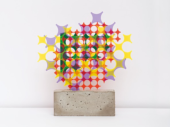 sculpture of colourful shapes on a concrete brick base